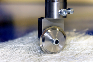 Closeup of blade cutting glass fiber