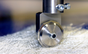 Closeup image of blade cutting fiberglass