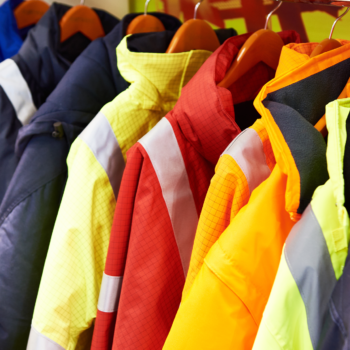 High visibility coats hang on wooden hangers