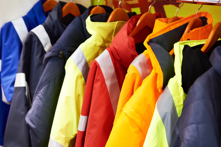 High visibility coats hang on wooden hangers